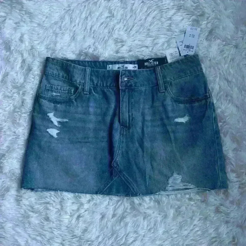 Hollister Denim Mini Skirt.  Size 9/waist 29.  Distressed w frayed edging. NWT.